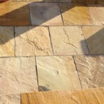 Indian Natural Stones yellow mint sandstone paving with smooth natural texture and light creamy tones, ideal for outdoor patios, walkways, and landscaping applications.