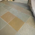 Indian Natural Stones Kota Brown limestone slabs and blocks stacked at stone yard for flooring, paving, and construction applications.