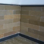 Indian Natural Stones Kota Brown limestone slabs and blocks stacked at stone yard for flooring, paving, and wall construction applications.