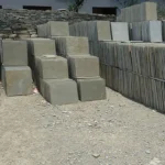 Indian Natural Stones Kota Brown limestone slabs and blocks stacked at stone yard for flooring, paving, and construction applications.