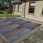Indian Natural Stones multicolor limestone paving installed for outdoor patio flooring in residential landscape design.