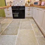 Indian Natural Stones Tandur Yellow limestone with natural textured finish for kitchen flooring applications.