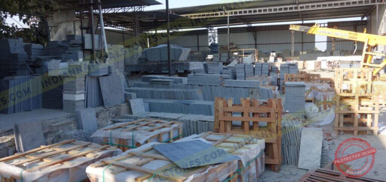 Natural stone slabs and packed crates at Indian Natural Stones north factory for processing, storage, and export operations
