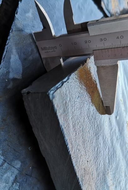Precision measurement of natural stone thickness using caliper at Indian Natural Stones quality control facility