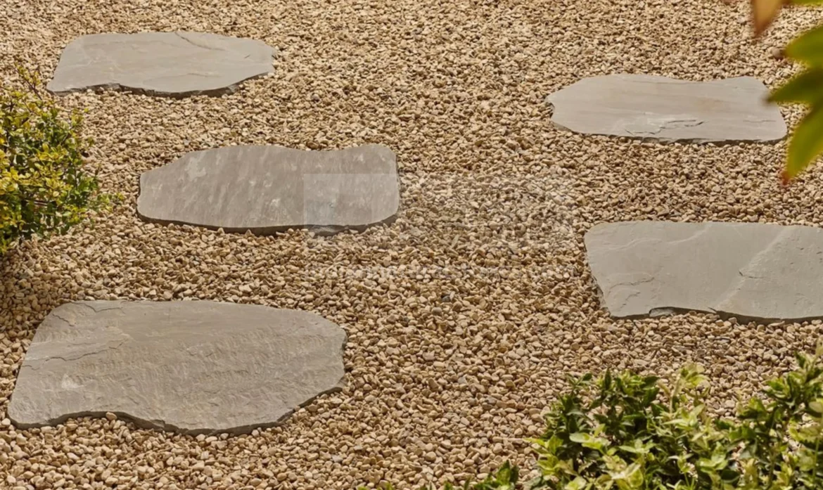 Autumn Brown Indian Sandstone stepping stones installed over decorative gravel, creating a natural garden pathway with premium sandstone supplied by Indian Natural Stones.