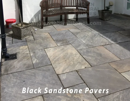 Residential patio featuring Black Sandstone paving slabs supplied by Indian Natural Stones for modern landscaping projects.