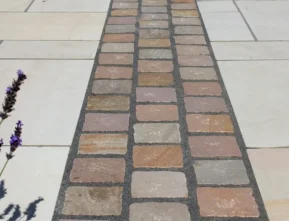 Natural stone cobblestone pathway inlay with paving slabs by Indian Natural Stones