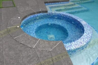 Flamed basalt stone pool coping and circular spa surround by Indian Natural Stones