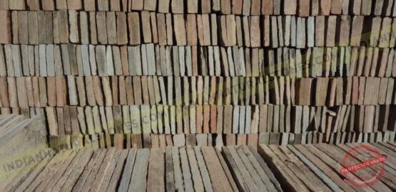 Stacked natural stone ledge panels at Indian Natural Stones factory, showcasing bulk inventory for stone wall cladding and export supply {{brizy_dc_image_alt imageSrc=