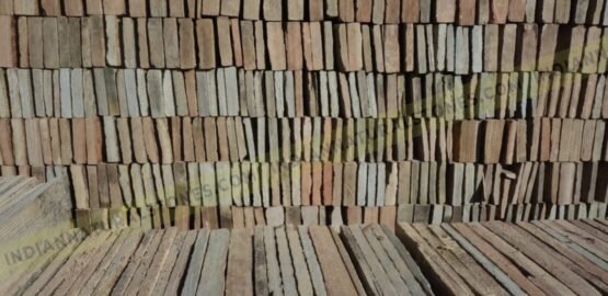 Stacked natural stone ledge panels at Indian Natural Stones factory, showcasing bulk inventory for stone wall cladding and export supply