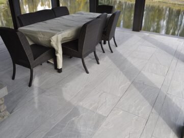 Indian Natural Stones Kandla grey sandstone paving with natural textured surface and elegant grey tones, ideal for outdoor patios, pathways, and landscaping applications.