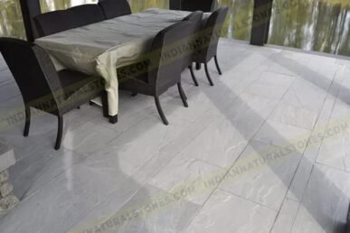 Indian Natural Stones Kandla grey sandstone paving with natural textured surface and elegant grey tones, ideal for outdoor patios, pathways, and landscaping applications.