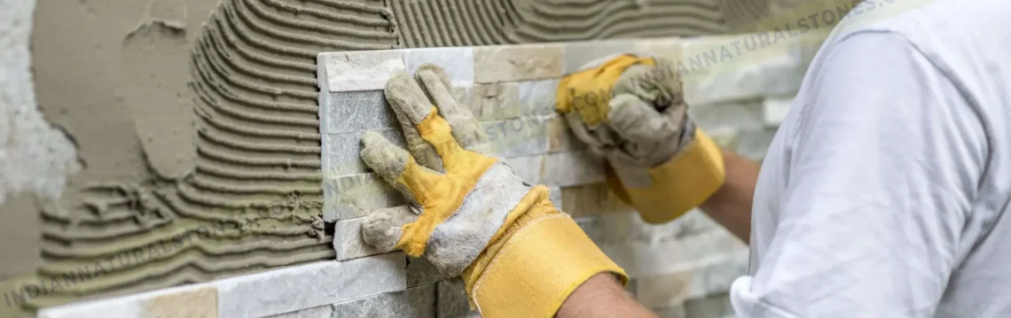 Installation of natural stone ledger panels by skilled workers at Indian Natural Stones, showcasing professional stone wall cladding application