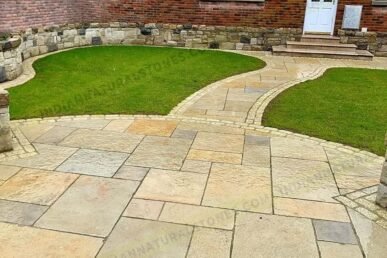 Limestone paving installed in a residential garden pathway by Indian Natural Stone, showcasing smooth natural texture, warm color tones, and durable outdoor stone flooring design.