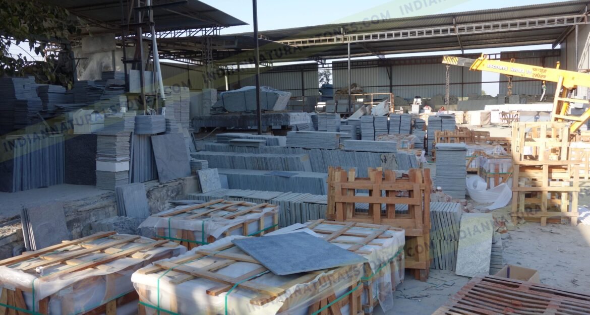Natural stone slabs and packed crates at Indian Natural Stones north factory for processing, storage, and export operations