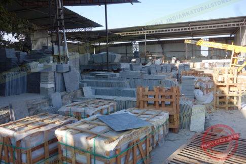 Natural stone slabs and packed crates at Indian Natural Stones north factory for processing, storage, and export operations {{brizy_dc_image_alt imageSrc=