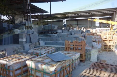 Natural stone slabs and packed crates at Indian Natural Stones north factory for processing, storage, and export operations