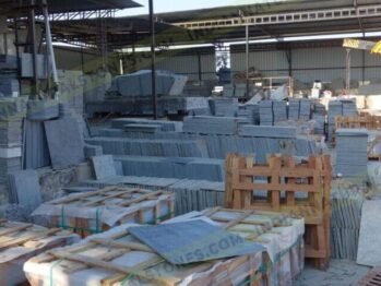 Natural stone slabs and packed crates at Indian Natural Stones north factory for processing, storage, and export operations