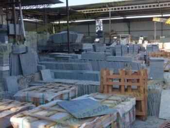 Natural stone slabs and packed crates at Indian Natural Stones north factory for processing, storage, and export operations