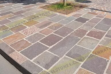 Porphyry stone paving installed for outdoor landscaping by Indian Natural Stone, showcasing multicolor natural stone tiles with durable, textured finish for walkways and public spaces.