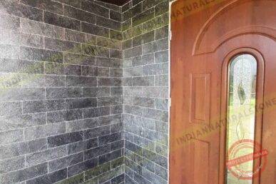 slates Natural slate stone wall cladding installed at a home entrance by Indian Natural Stone, showcasing textured dark slate tiles for exterior and interior architectural design.