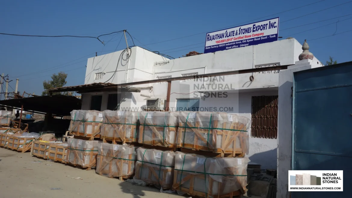 Stacked Indian slate stone pallets at supplier warehouse ready for global export