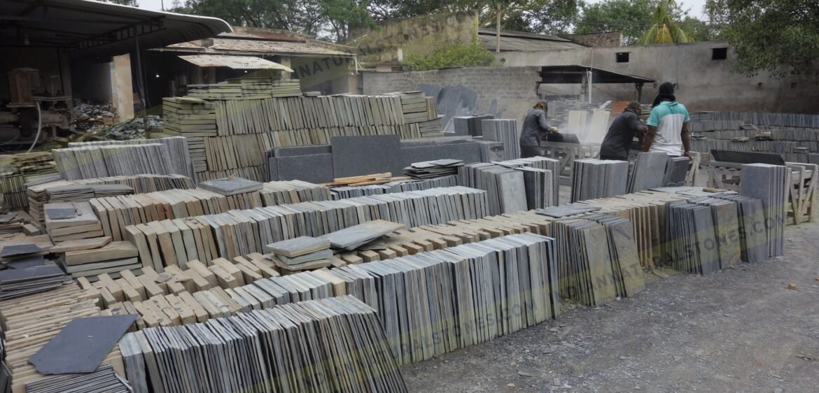 south-factory-scaled (1) Stacked natural stone slabs and tiles at Indian Natural Stones factory yard for processing and export