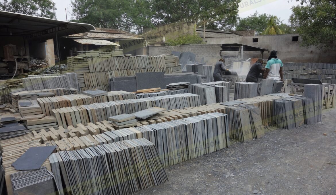 south-factory-scaled (1) Stacked natural stone slabs and tiles at Indian Natural Stones factory yard for processing and export