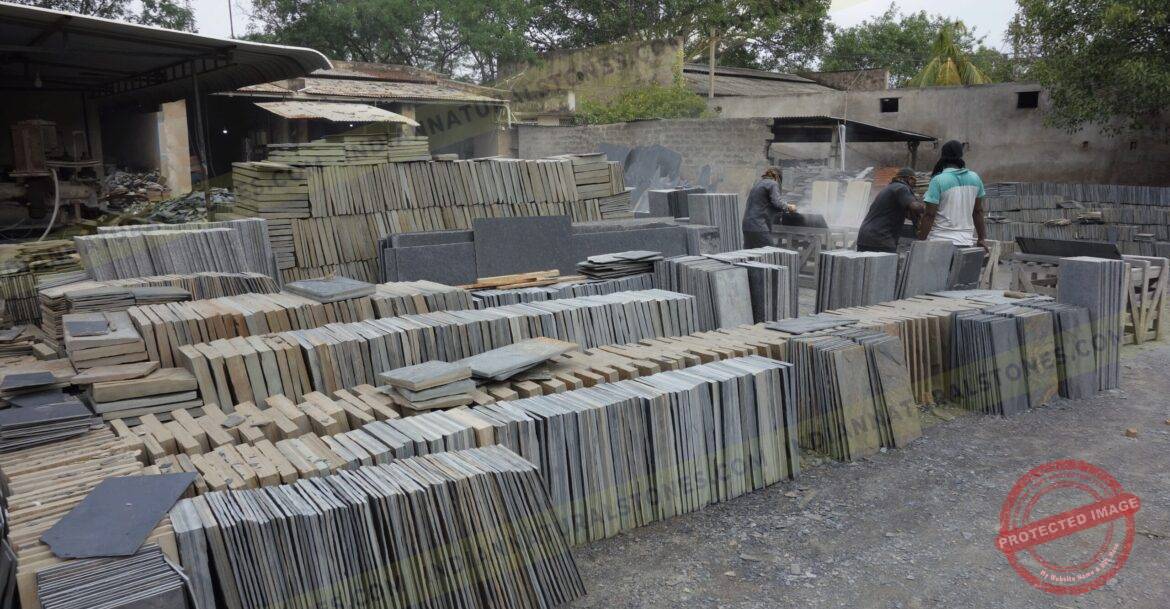 south-factory-scaled (1) Stacked natural stone slabs and tiles at Indian Natural Stones factory yard for processing and export