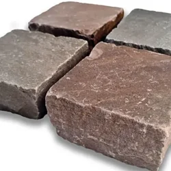 Autumn blend sandstone cobblestone blocks with natural split edges and textured surface by Indian Natural Stones.