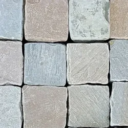 Autumn blend tumbled cobblestone pavers with smooth edges and natural stone texture arranged in a pattern by Indian Natural Stones.