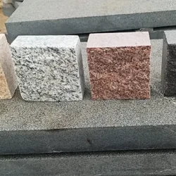 Natural granite cobblestone samples in multiple colors and finishes for outdoor paving by Indian Natural Stones.