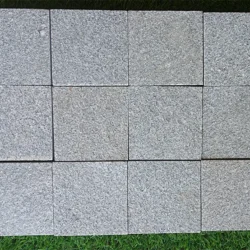 Natural grey granite cobblestone block with rough textured finish for paving by Indian Natural Stones.