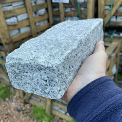 Natural grey granite cobblestone block with rough textured finish for paving by Indian Natural Stones.