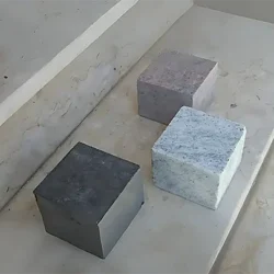 Natural granite cobblestone samples in multiple colors and finishes for outdoor paving by Indian Natural Stones.