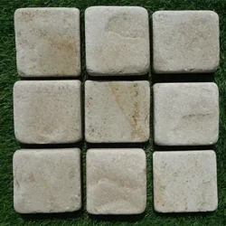 Tumbled rice white sandstone cobblestone pavers with smooth edges for outdoor paving by Indian Natural Stones.