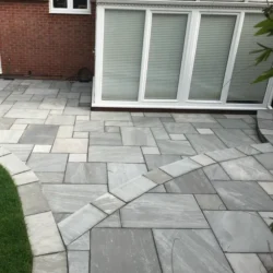Grey sandstone natural stone paving slabs installed for patio and garden flooring by Indian Natural Stones
