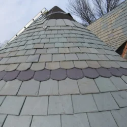 Scalloped slate roofing tiles installed in overlapping pattern by Indian Natural Stones