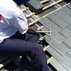 Worker working for fixing and installation of slate roofing by Indian Natural Stones