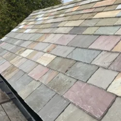 Multicolor slate roofing tiles installed on sloped roof by Indian Natural Stones