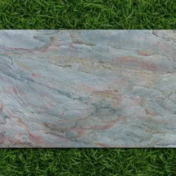 Burning Forest flexible stone veneer sheet with rich earthy textures displayed on grass by Indian Natural Stones