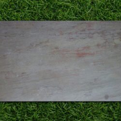 Steel Copper flexible stone veneer sheet with rich earthy textures displayed on grass by Indian Natural Stones