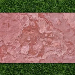 Terra Red flexible stone veneer sheet with rich earthy textures displayed on grass by Indian Natural Stones