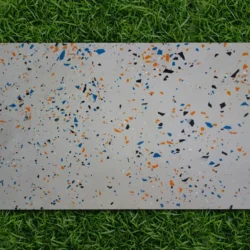 Flexible stone veneer sheet in terrazzo white finish placed on grass by Indian Natural Stones