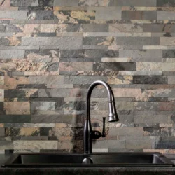 Natural 3D peel and stick stone panels installed as kitchen backsplash with sink by Indian Natural Stones