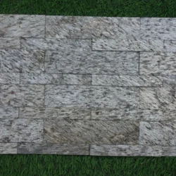 3D peel and stick stone panels by Indian Natural Stones in Silver Shine Gold finish, featuring a natural textured stacked stone design for elegant and easy wall cladding.
